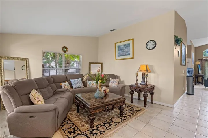 Living area featuring light tile patterned flooring and baseboards