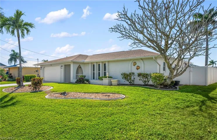 Ranch-style home featuring stucco siding and an attached garage