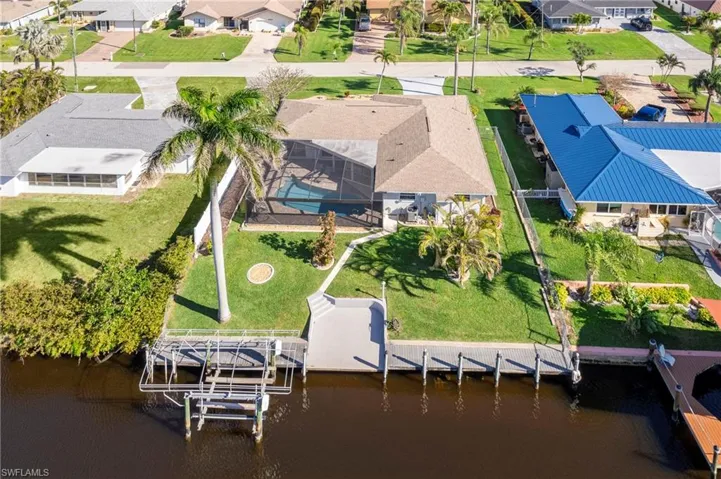 Aerial perspective of suburban area with a nearby body of water