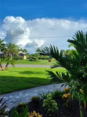 View of property's community with a yard