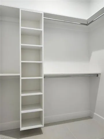 Walk in closet with tile patterned flooring