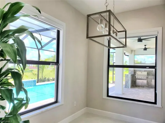 Unfurnished dining area featuring an inviting chandelier and tile patterned floors