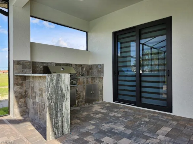 Property entrance featuring a patio, exterior kitchen, and sink