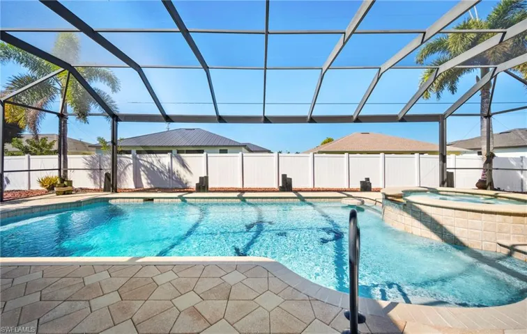 Integrated pool / hot tub with glass enclosure, a fenced backyard, a sunroom, and a patio area