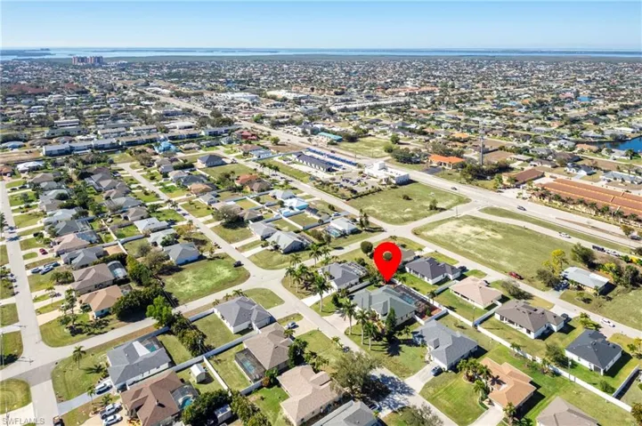 Aerial view of property's location featuring nearby suburban area