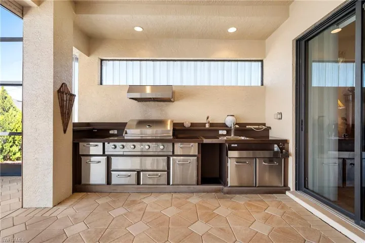 View of patio / terrace with exterior kitchen and a sink