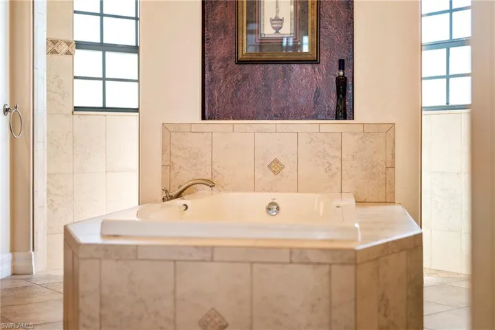 Bathroom featuring light tile patterned floors and a bath