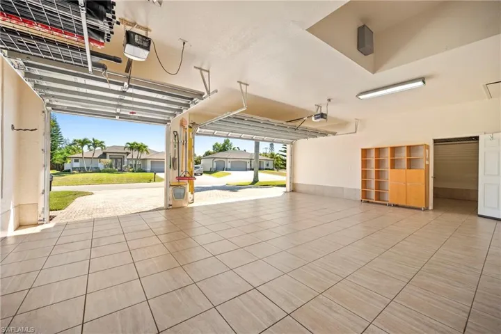 Garage featuring a residential view and a garage door opener