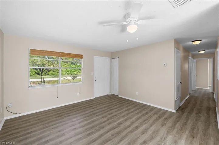 Livingroom featuring wood finished floors, ceiling fan, and a textured ceiling