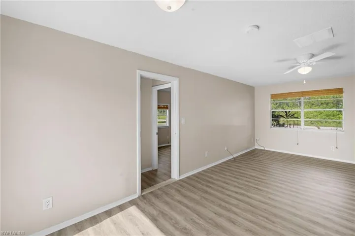 Unfurnished room with wood finished floors and ceiling fan