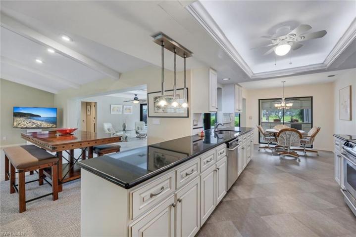 White Wood Kitchen Cabinets with Black Granite, SS Appliances, Tray Ceiling