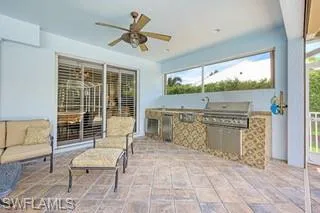 View of patio featuring area for grilling, grilling area, and ceiling fan