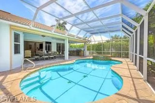 View of pool featuring a patio, ceiling fan, a lanai, and an in ground hot tub