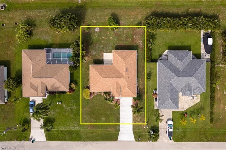 Aerial view of property and surrounding area with property parcel outlined