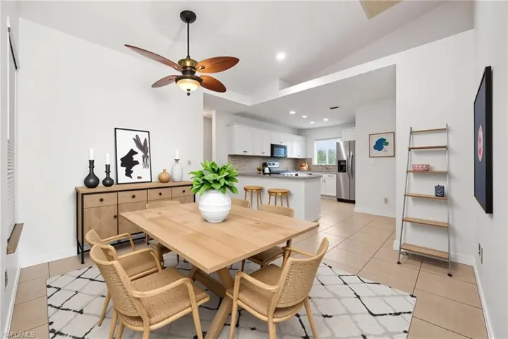 Dining room featuring light tile patterned floors, recessed lighting, a ceiling fan, and lofted ceiling