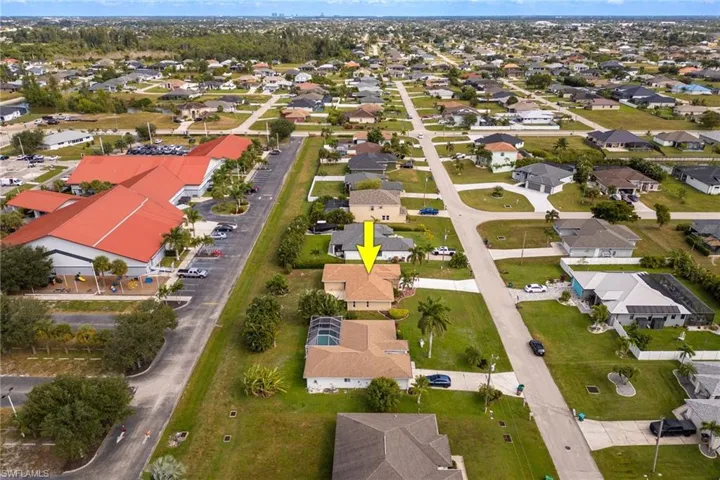 Aerial overview of property's location with nearby suburban area