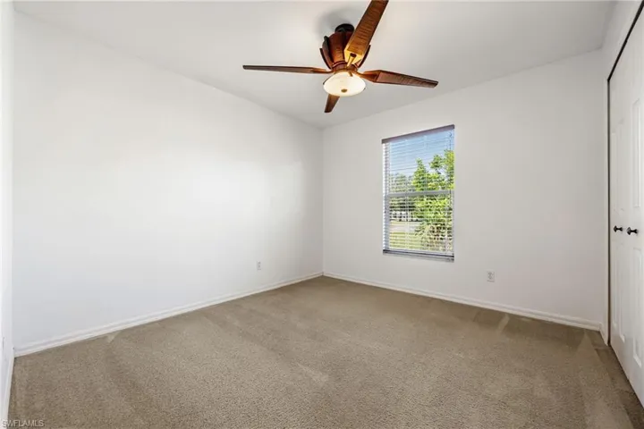 Spare room with carpet flooring and a ceiling fan