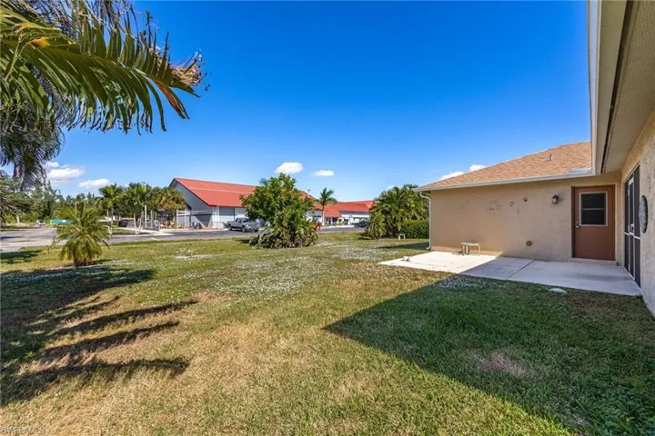 View of green lawn with a patio