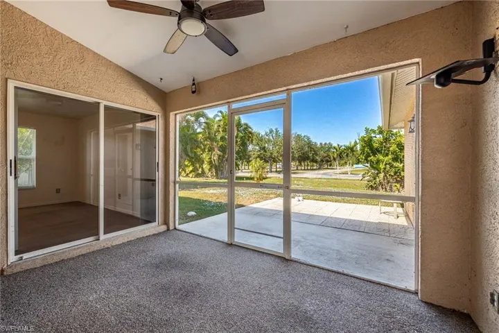 Unfurnished sunroom featuring healthy amount of natural light and a ceiling fan