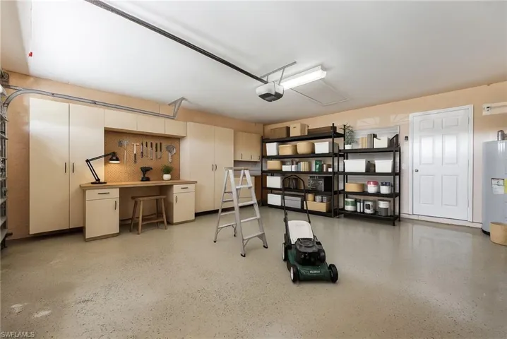 Garage with water heater and a garage door opener