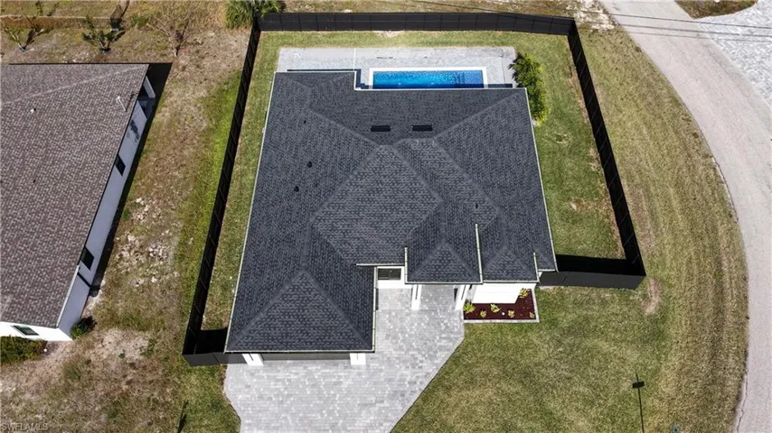 View of subject property featuring a pool