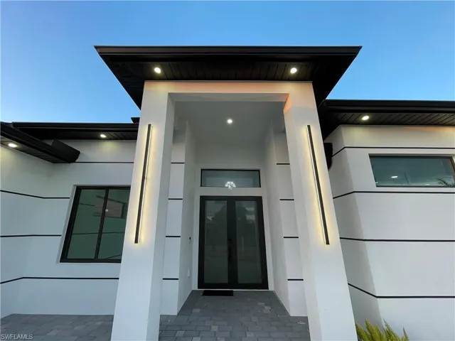 Entrance to property with french doors and stucco siding