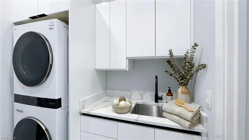 Laundry area with stacked washing machine and dryer