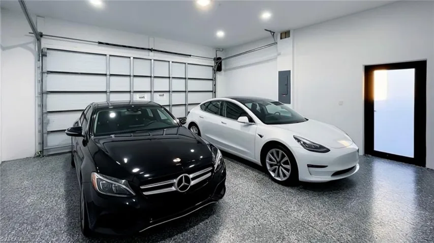 Garage with electric panel and recessed lighting