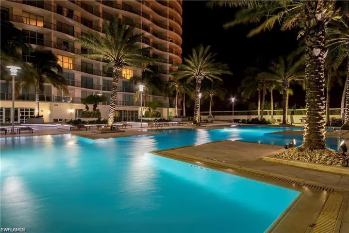Pool at twilight with a community pool and a patio area
