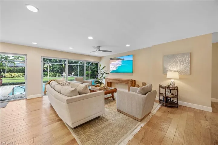 Living room featuring ceiling fan and light wood-type flooring