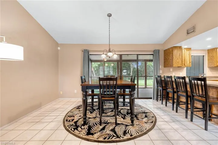 Dining area with sliding glass doors to the screened lanai & backyard