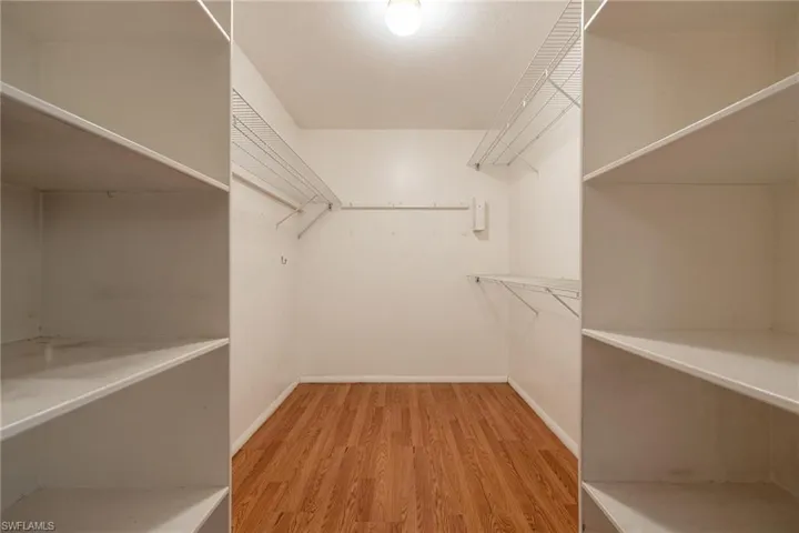 Spacious closet with organizers in primary bedroom