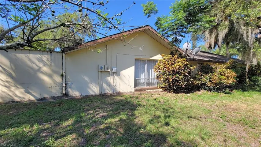 View of side of home featuring a lawn