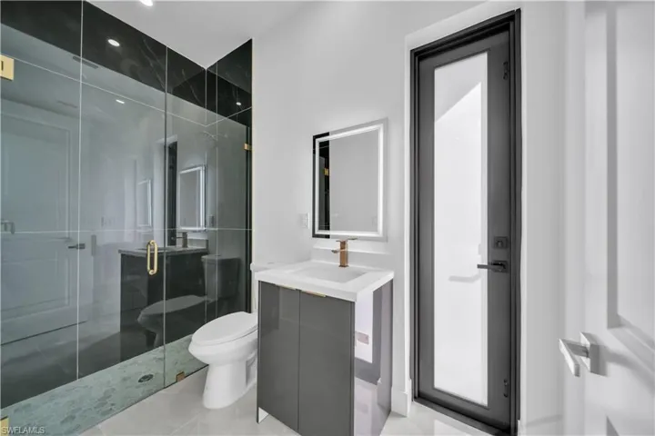 Full bathroom featuring vanity, a shower stall, and light tile patterned floors