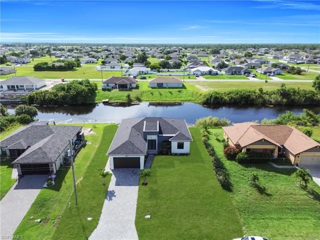 Aerial perspective of suburban area with a nearby body of water