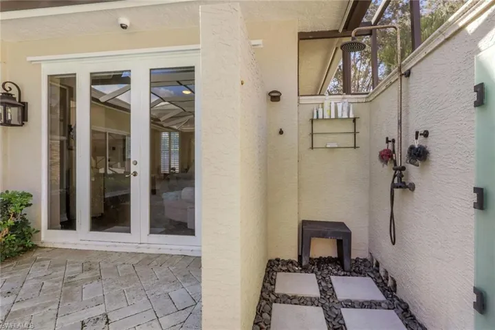 Doorway to property with french doors, a patio, and stucco siding