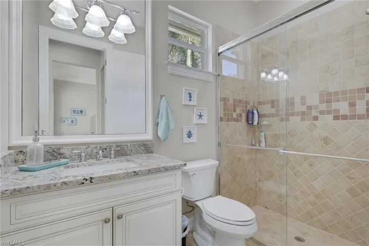 Bathroom with vanity and a shower stall