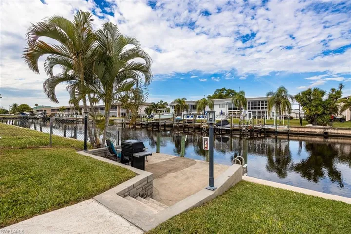 Dock with a yard, a water view, and a residential view