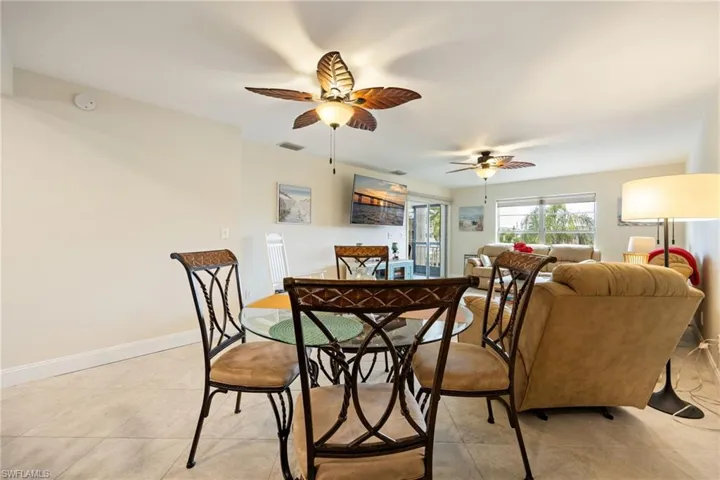 Dining room with a ceiling fan and light tile patterned floors