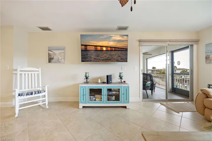 Living room with baseboards and light tile patterned flooring