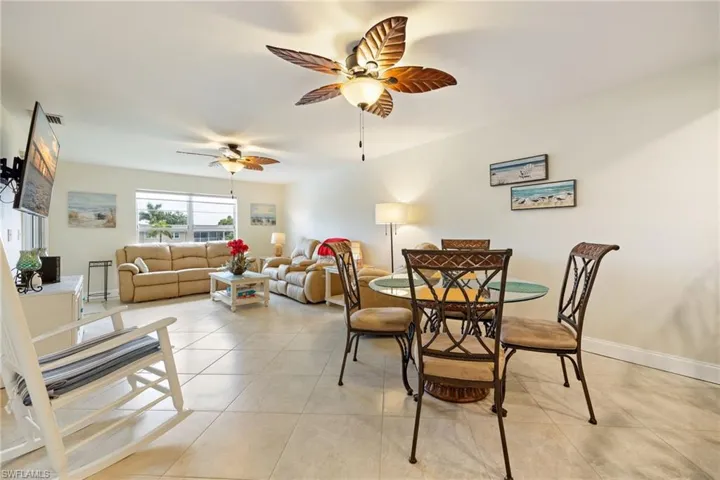 Dining space with light tile patterned floors and a ceiling fan