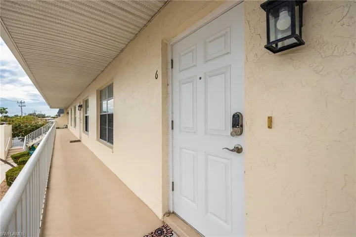 Entrance to property with stucco siding