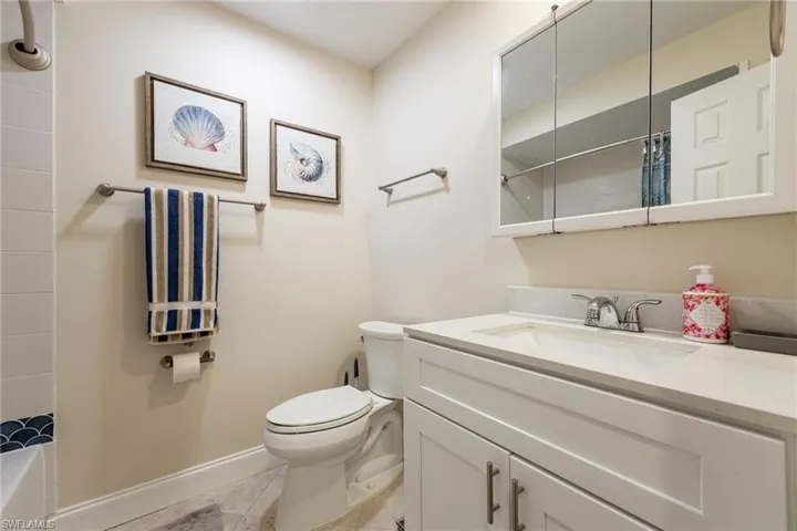 Bathroom with vanity and light tile patterned flooring