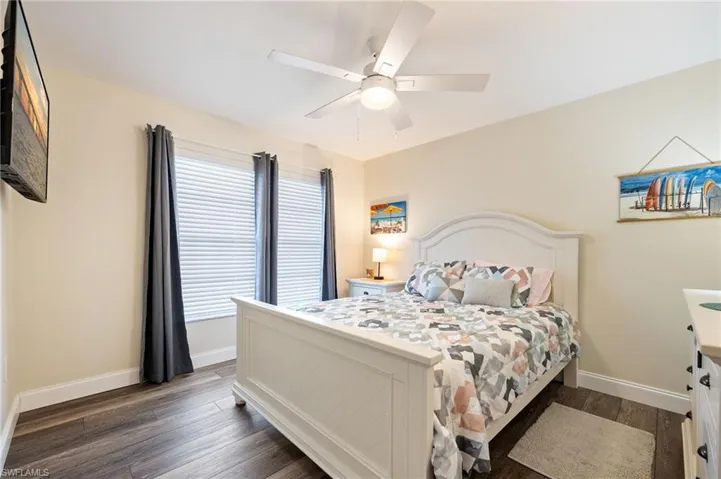 Bedroom featuring dark wood finished floors and ceiling fan