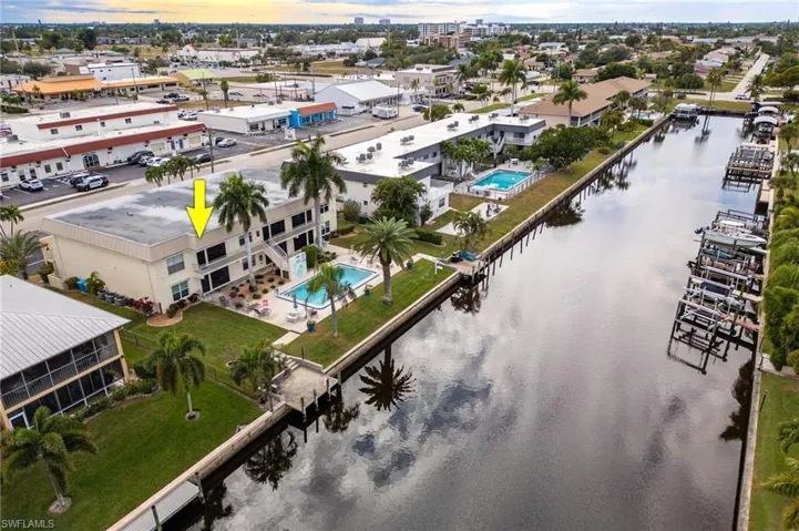 Aerial view of a pool and a nearby body of water