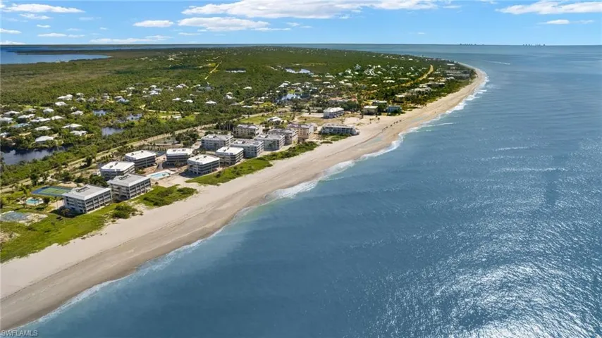 Aerial view featuring a water view and a view of the beach