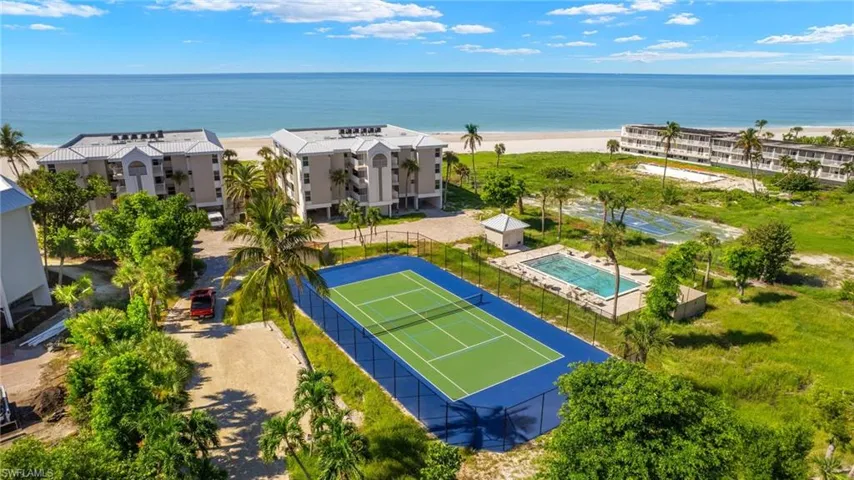 Drone / aerial view with a water view and a beach view