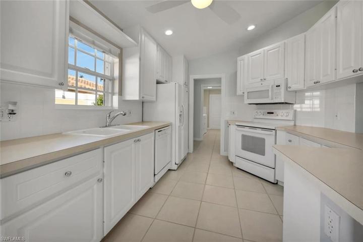 Bright kitchen with white cabeintry.