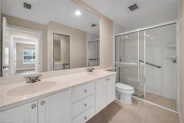 Primary bathroom with dual sinks & walk-in shower.