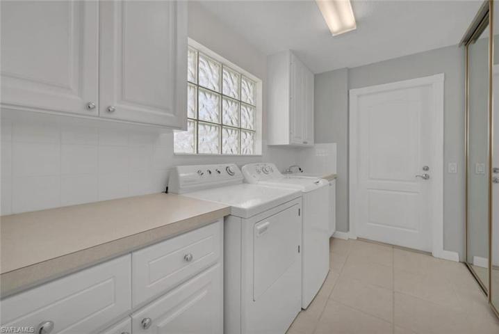 Spacious laundry room with new washing machine.